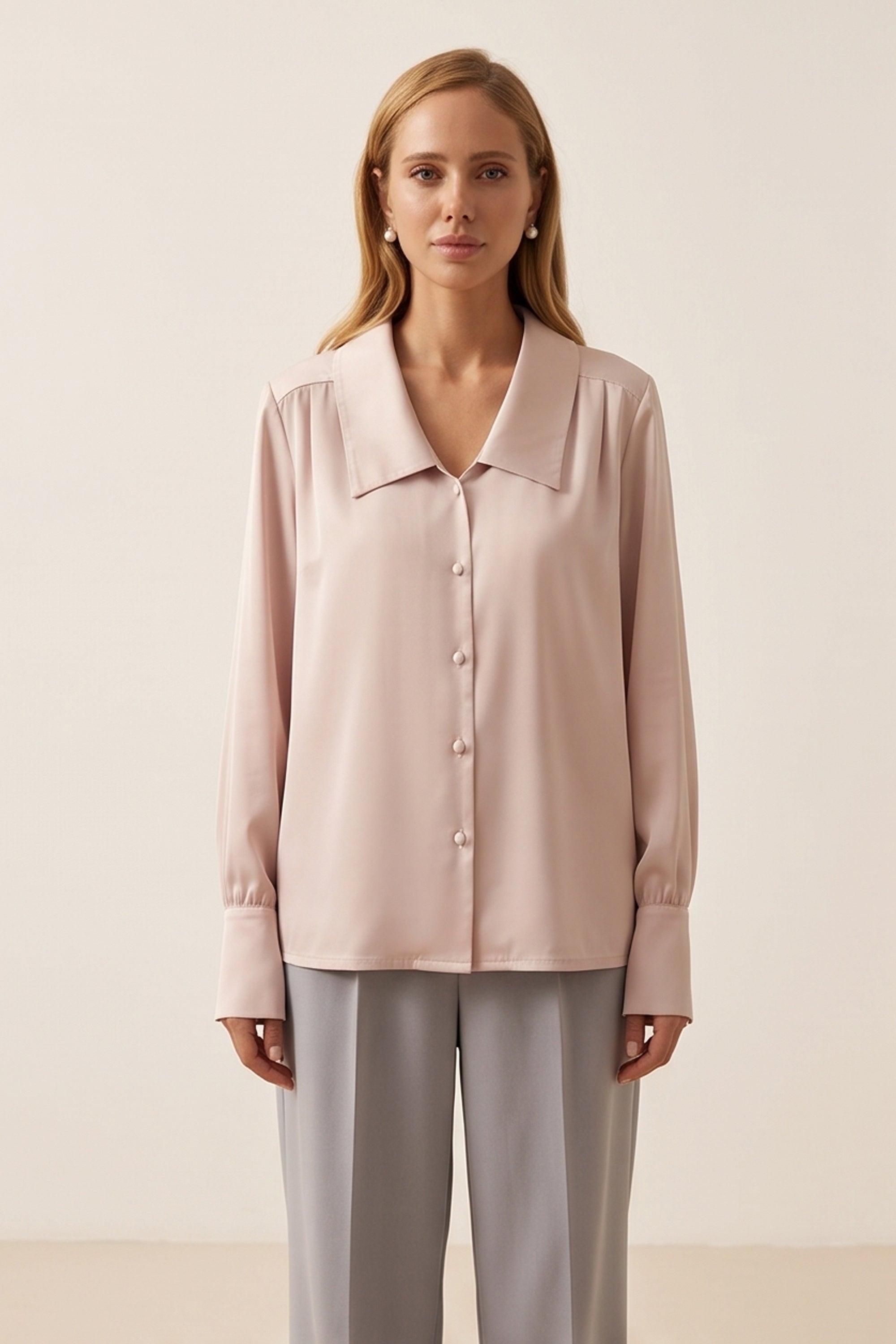 Front view of a woman wearing the pink Timeless Blouse by FemeAdor featuring a flattering fit, ideal for layering or wearing solo in professional and casual settings.