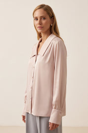 Side view of a woman wearing the pink Timeless Blouse by FemeAdor featuring a flattering fit, ideal for layering or wearing solo in professional and casual settings.