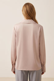 Back view of a woman wearing the pink Timeless Blouse by FemeAdor featuring a flattering fit, ideal for layering or wearing solo in professional and casual settings.