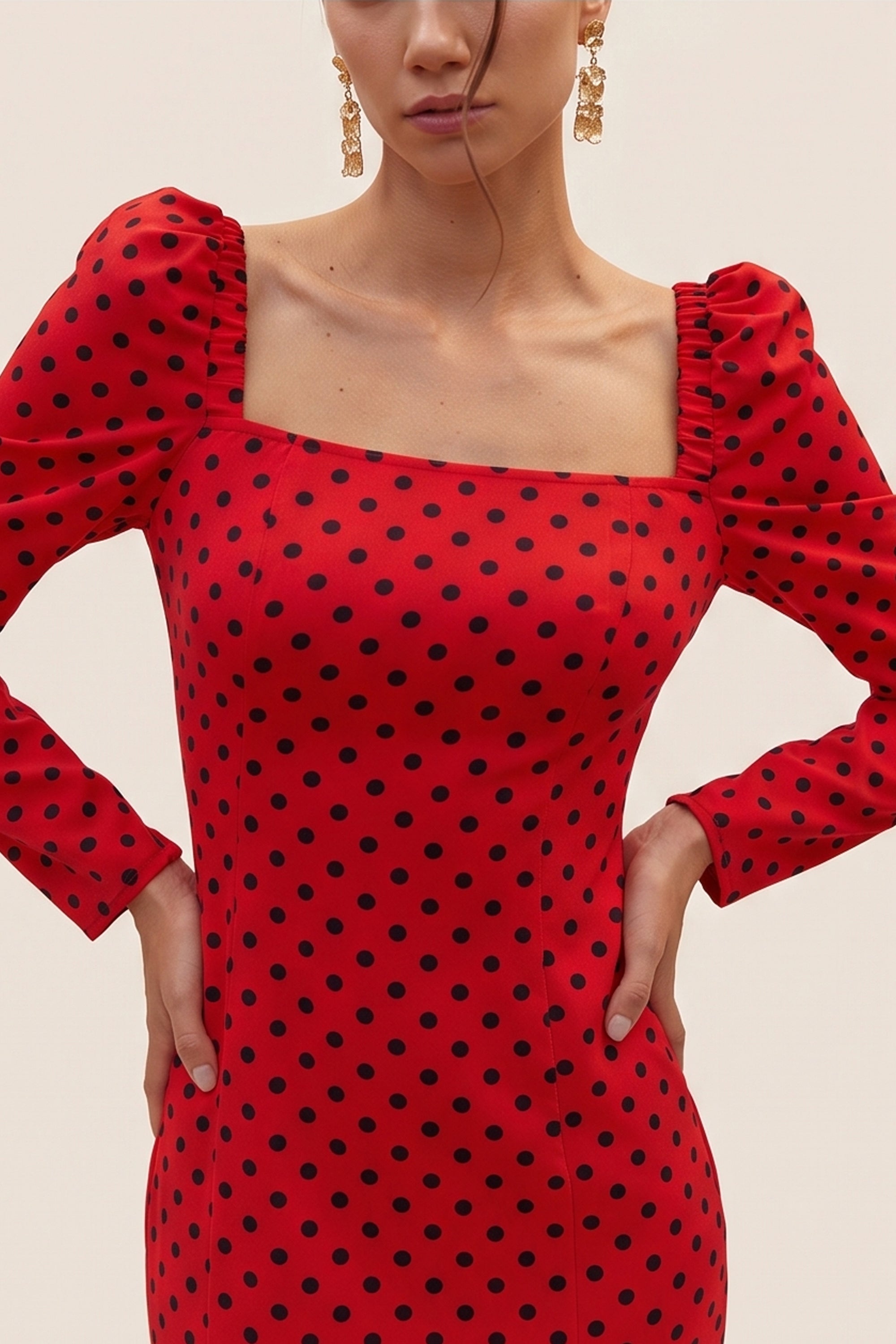 Close up view of a woman wearing the red Celestra Midi Dress by FemeAdor featuring a flattering fit-and-flare silhouette and timeless polka dot pattern