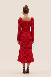 Back view of a woman wearing the red Celestra Midi Dress by FemeAdor featuring a flattering fit-and-flare silhouette and timeless polka dot pattern