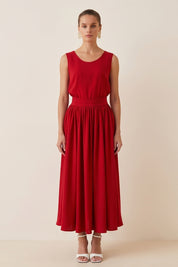 Woman wearing the red Enchanting Skirt by FemeAdor featuring a flowing midi silhouette and soft fabric, ideal for casual or formal wear