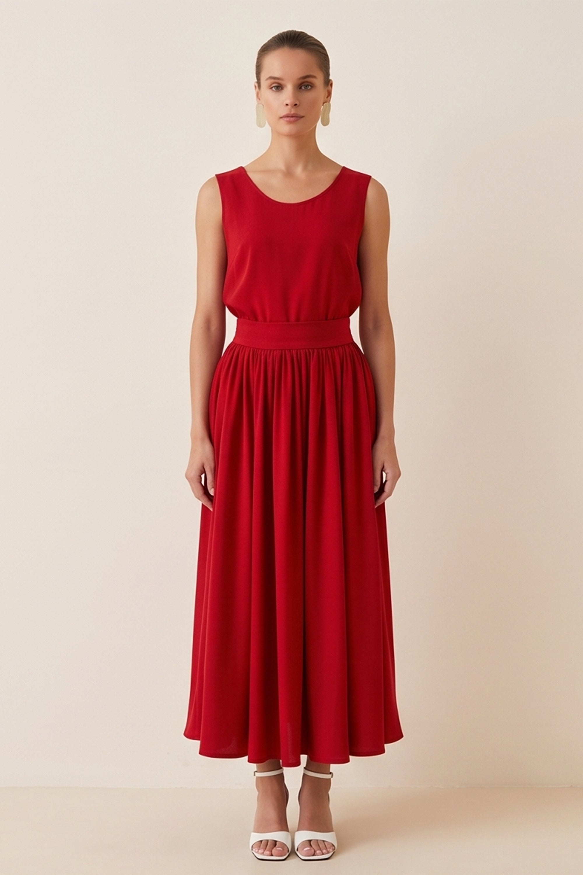 Woman wearing the red Enchanting Skirt by FemeAdor featuring a flowing midi silhouette and soft fabric, ideal for casual or formal wear