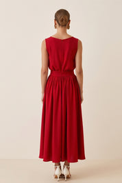 Back veiw of a woman wearing the red Enchanting Skirt by FemeAdor featuring a flowing midi silhouette and soft fabric, ideal for casual or formal wear