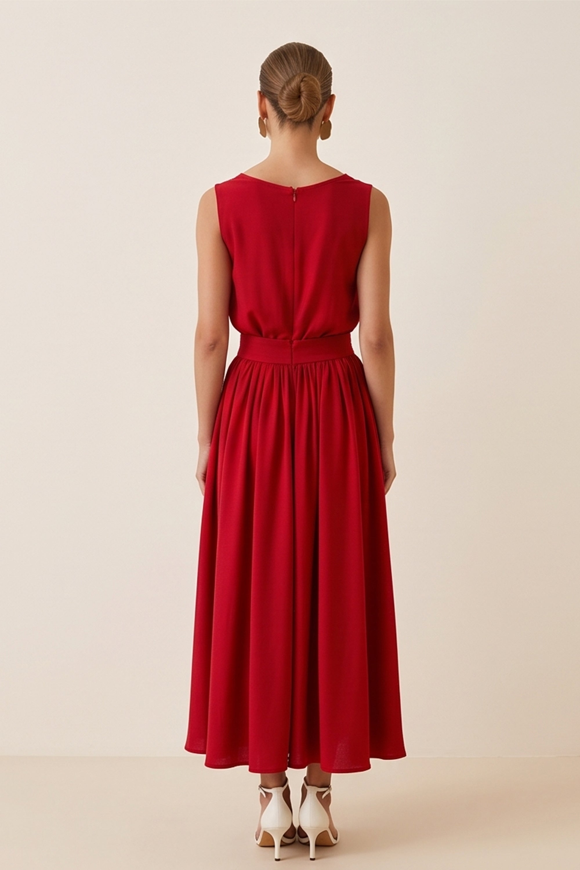 Back veiw of a woman wearing the red Enchanting Skirt by FemeAdor featuring a flowing midi silhouette and soft fabric, ideal for casual or formal wear
