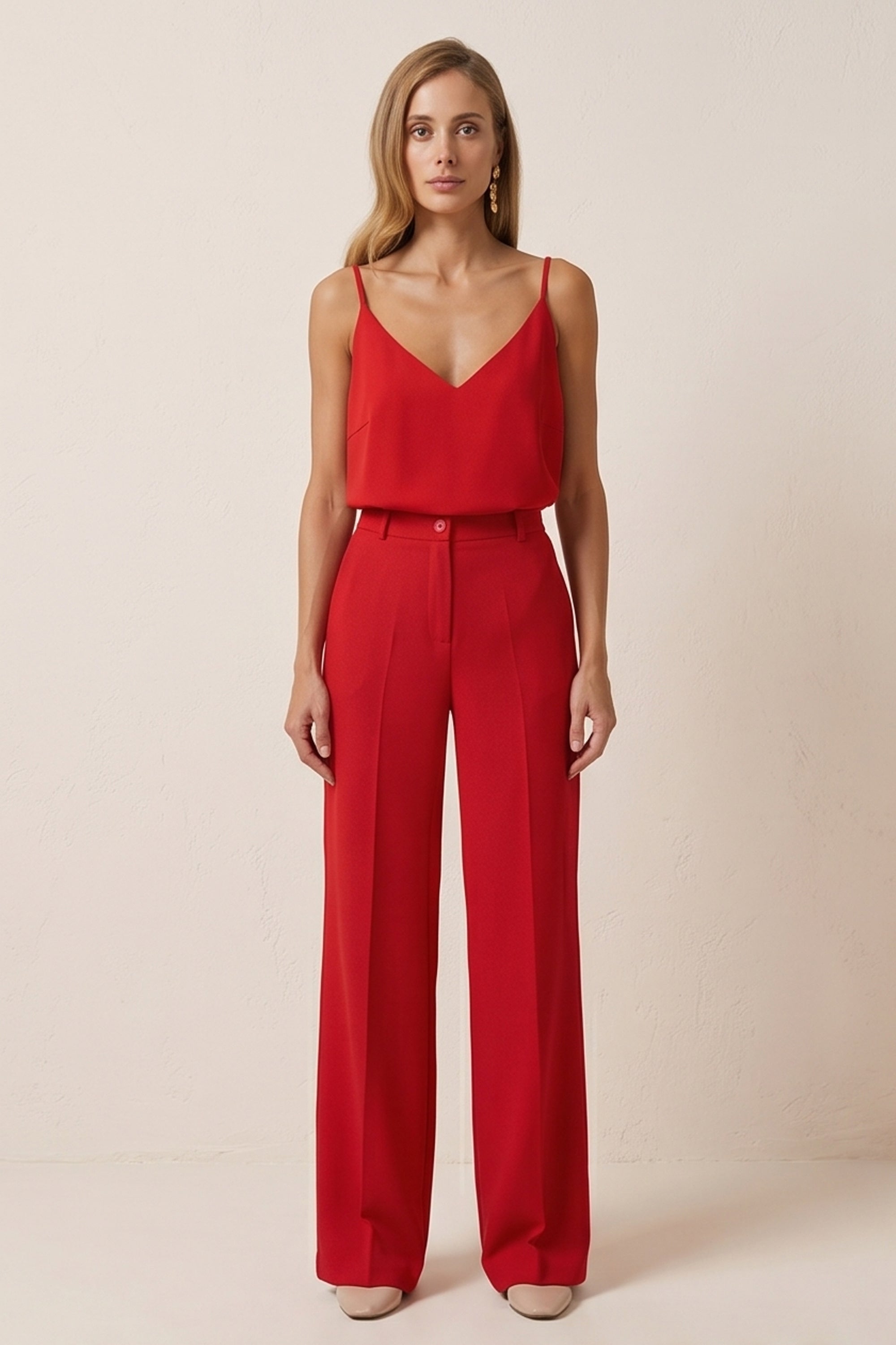 Front view of a woman wearing red Moda Trousers by FemeAdor featuring a high-waisted, wide-leg tailored fit for modern styling