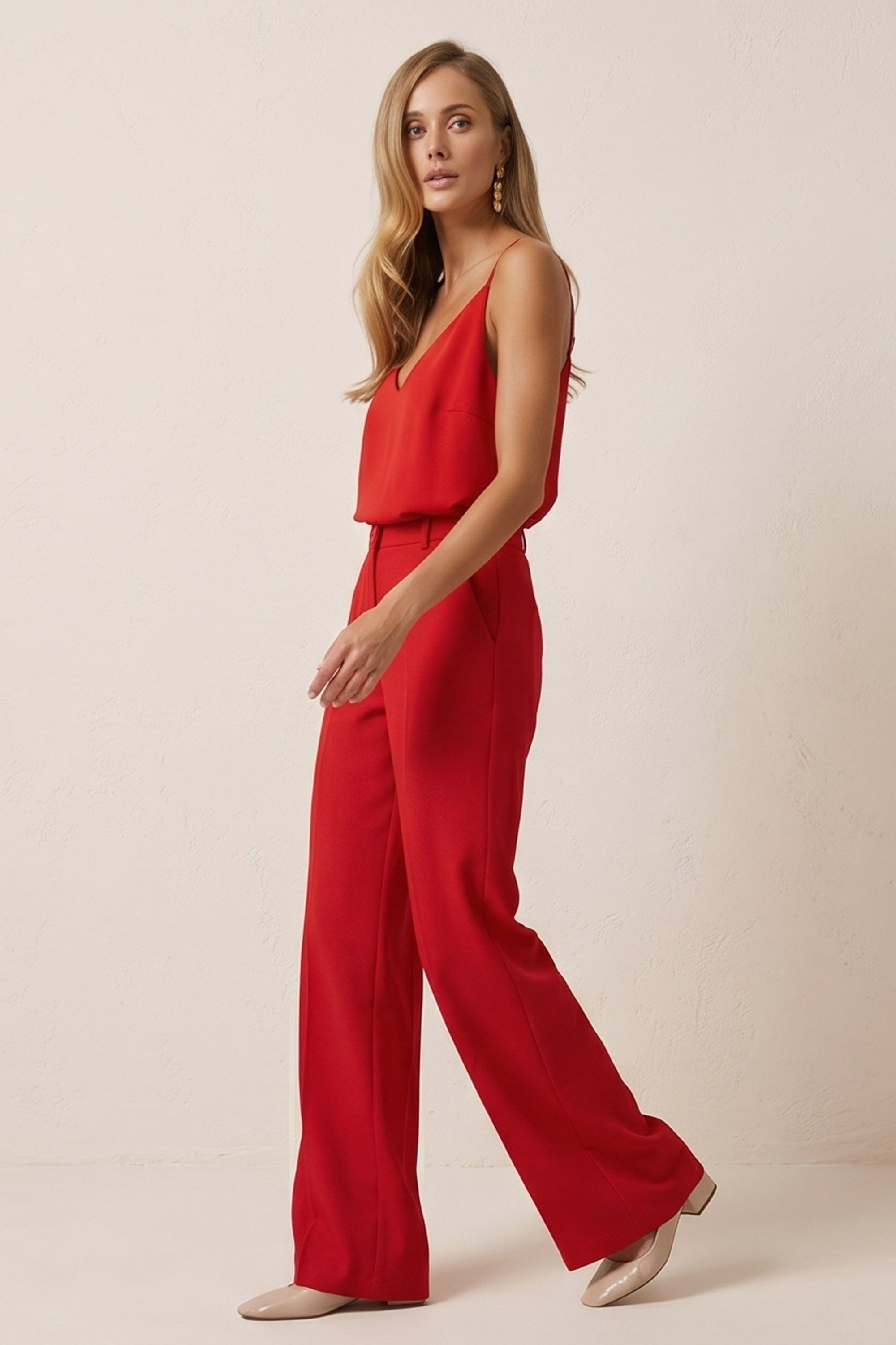Side view of a woman wearing red Moda Trousers by FemeAdor featuring a high-waisted, wide-leg tailored fit for modern styling