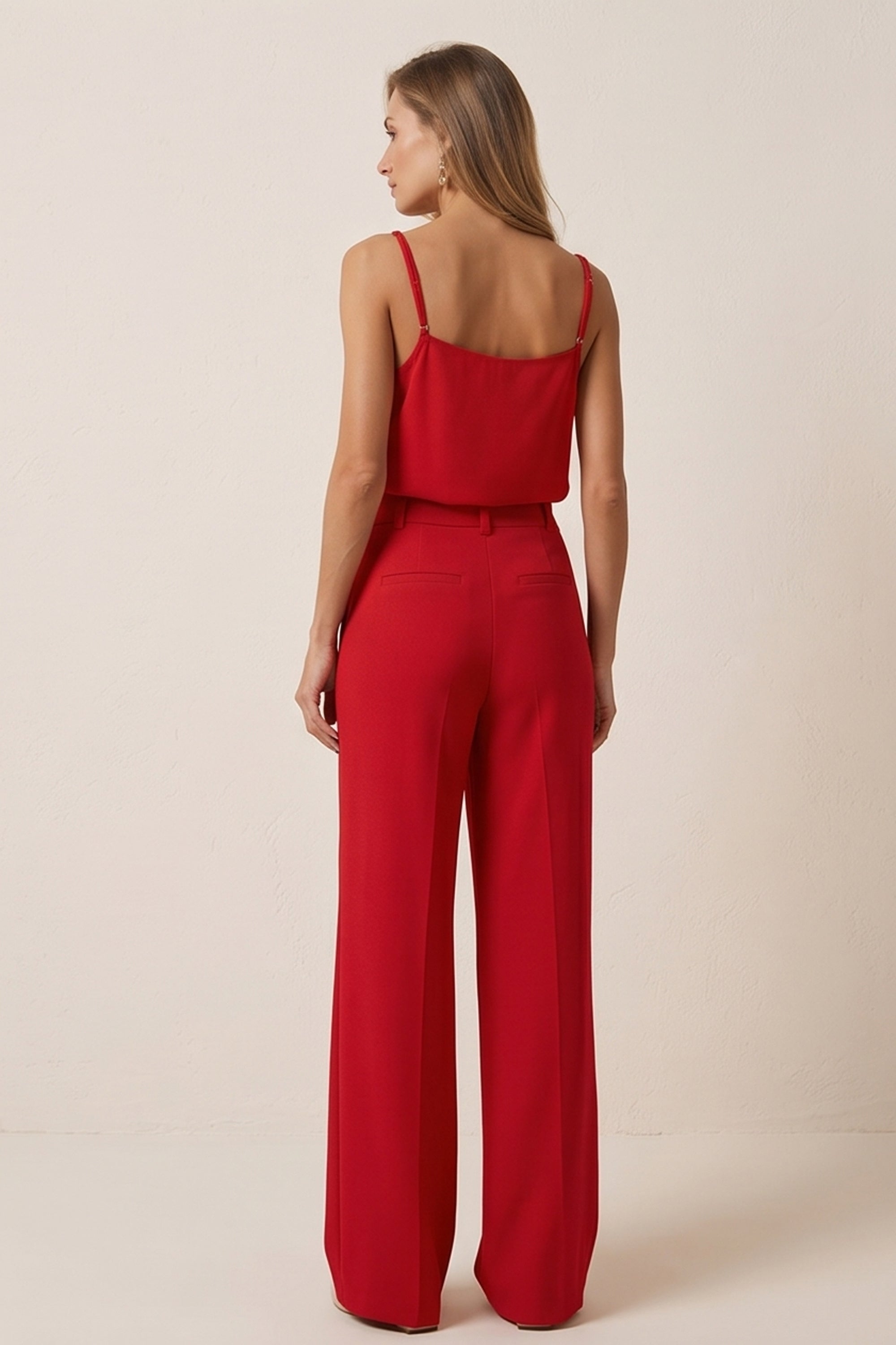Back view of a woman wearing red Moda suit pants by FemeAdor featuring a high-waisted, wide-leg tailored fit for modern styling