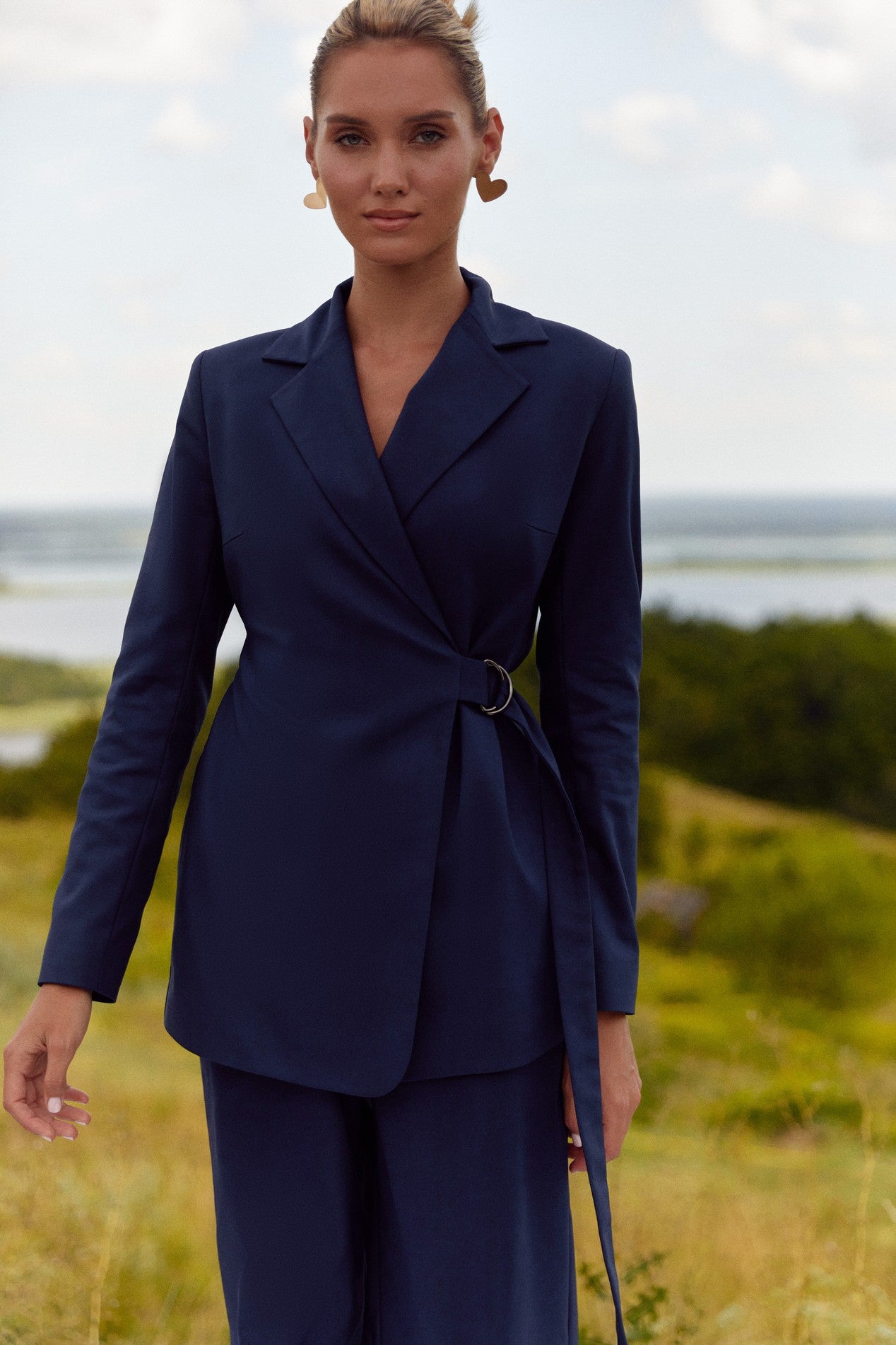 Front view of Regal Blazer by FemeAdor in navy blue featuring a tailored belted silhouette, ideal for professional and casual styling