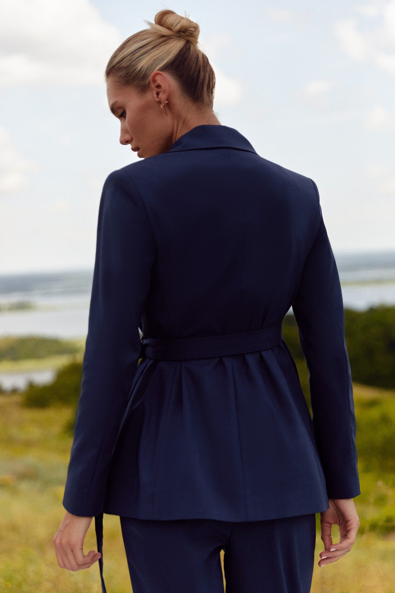 Back view of Regal Blazer by FemeAdor in navy blue featuring a tailored belted silhouette, ideal for professional and casual styling