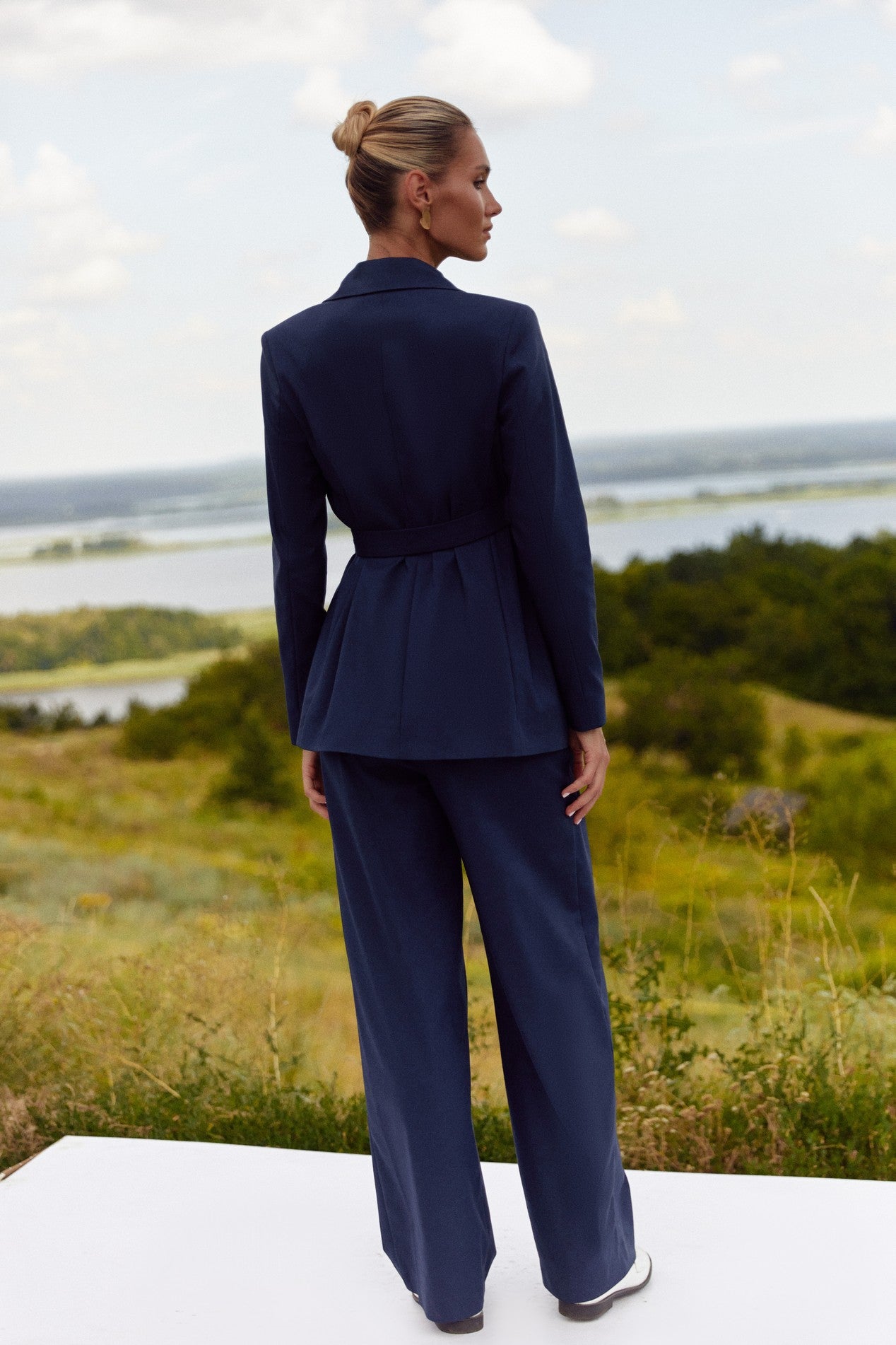Back view of Regal Trousers by FemeAdor in navy blue with high-waisted, wide-leg tailored fit, perfect for professional and casual styling