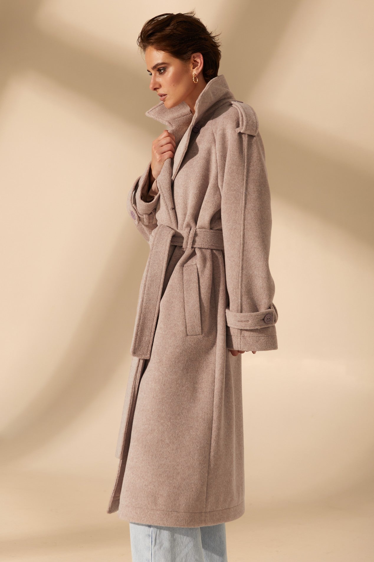 Side view of Royale Overcoat by FemeAdor in beige featuring wide lapels and a tailored silhouette, ideal for both professional and casual styling