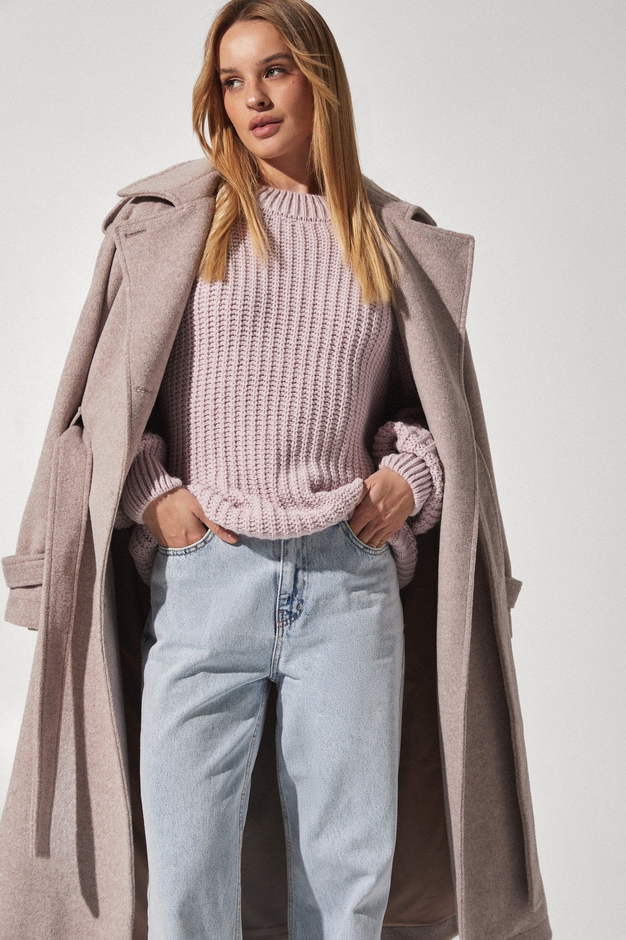 Close up of Royale Overcoat by FemeAdor in beige featuring wide lapels and a tailored silhouette, ideal for both professional and casual styling
