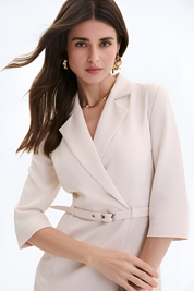 Close up of a woman wearing the vespera mini dress-jacket in structured beige design by FemeAdor