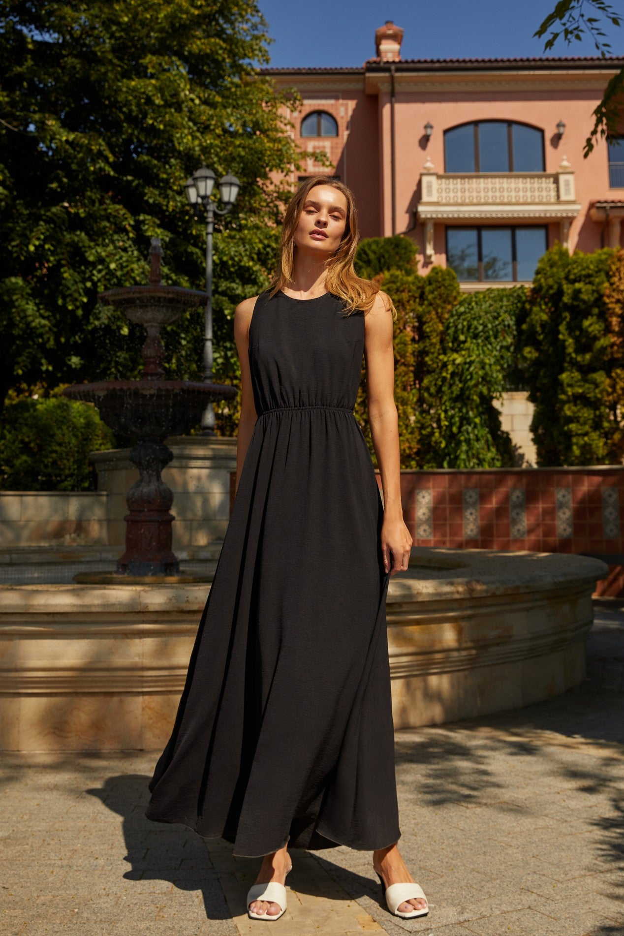 Front view of the Virella Maxi Dress in black with sleeveless design, open back, and floor-length silhouette for elegant evening wear