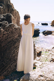 Front view of the Virella Maxi Dress in white with sleeveless design, open back, and floor-length silhouette for elegant evening wear