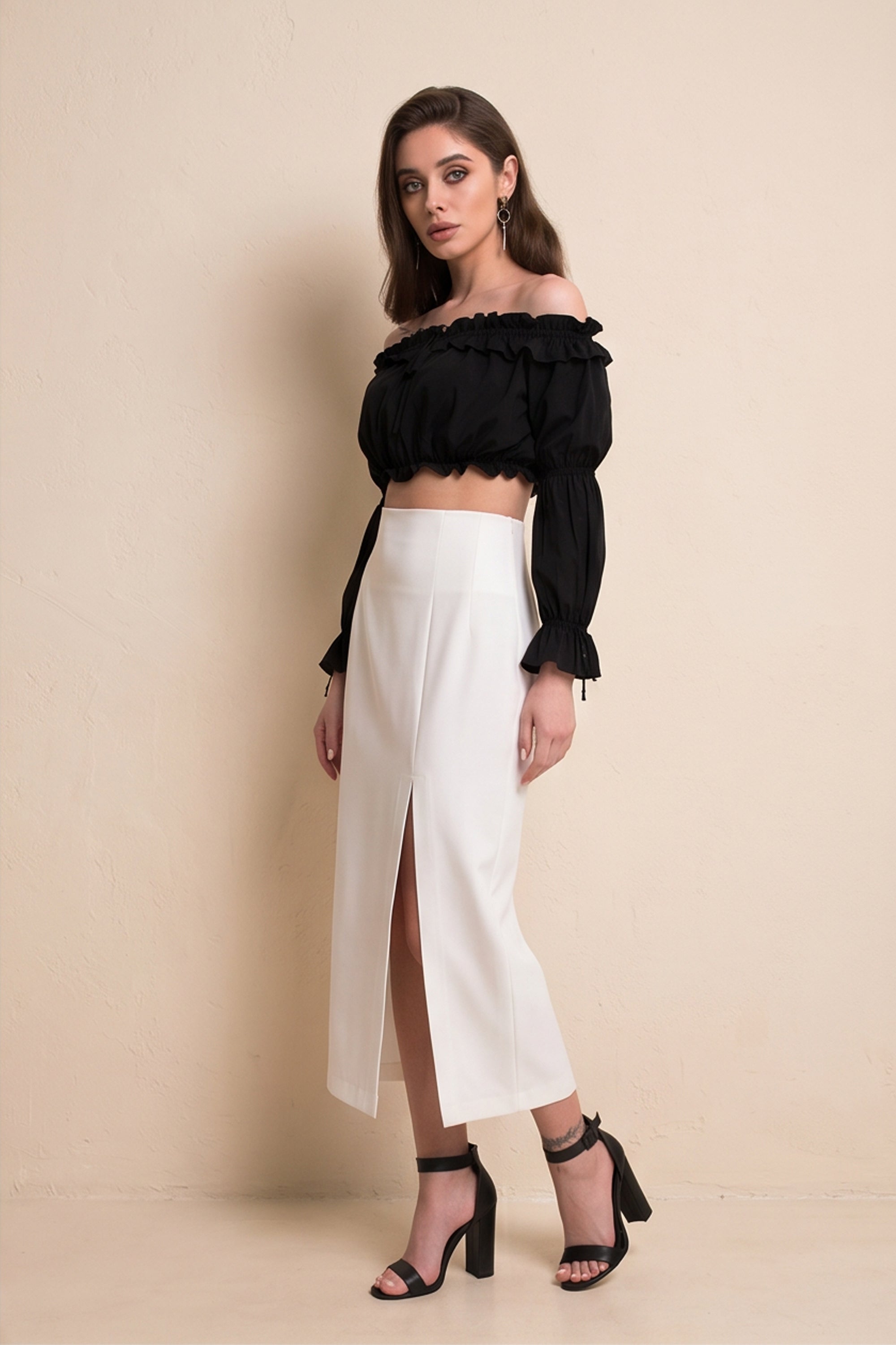 Side view of Ardor Skirt by FemeAdor in white featuring a high-waisted, midi-length silhouette with delicate tailoring, ideal for both professional and casual styling