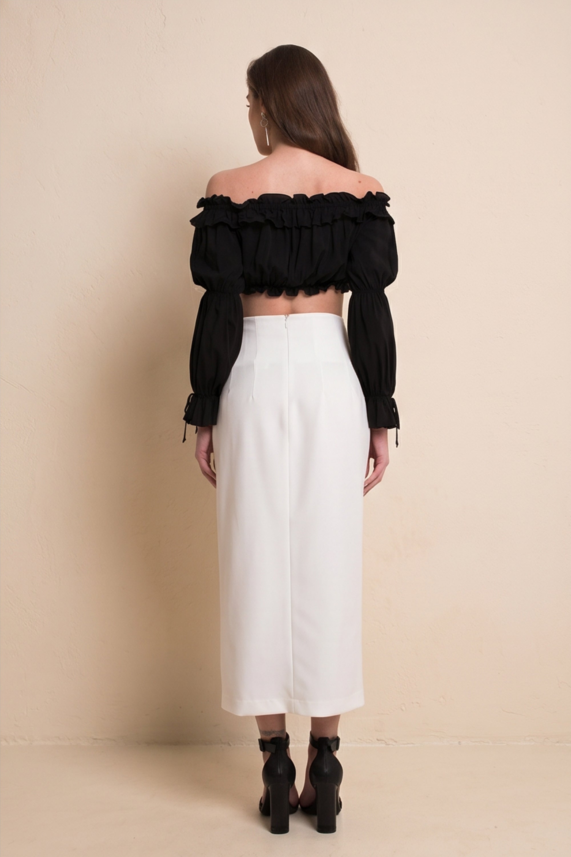 Back view of Ardor Skirt by FemeAdor in white featuring a high-waisted, midi-length silhouette with delicate tailoring, ideal for both professional and casual styling