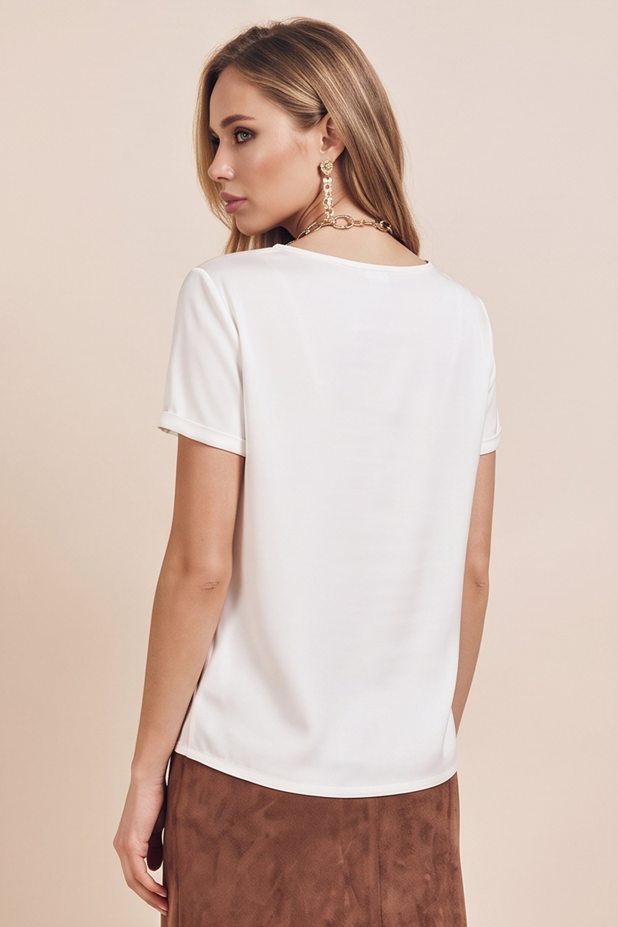 Back view of a woman wearing the white Pearl T-shirt by FemeAdor with silk-like finish and relaxed flattering fit