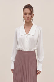 Front view of a woman wearing the white Timeless Blouse by FemeAdor featuring a flattering fit, ideal for layering or wearing solo in professional and casual settings.
