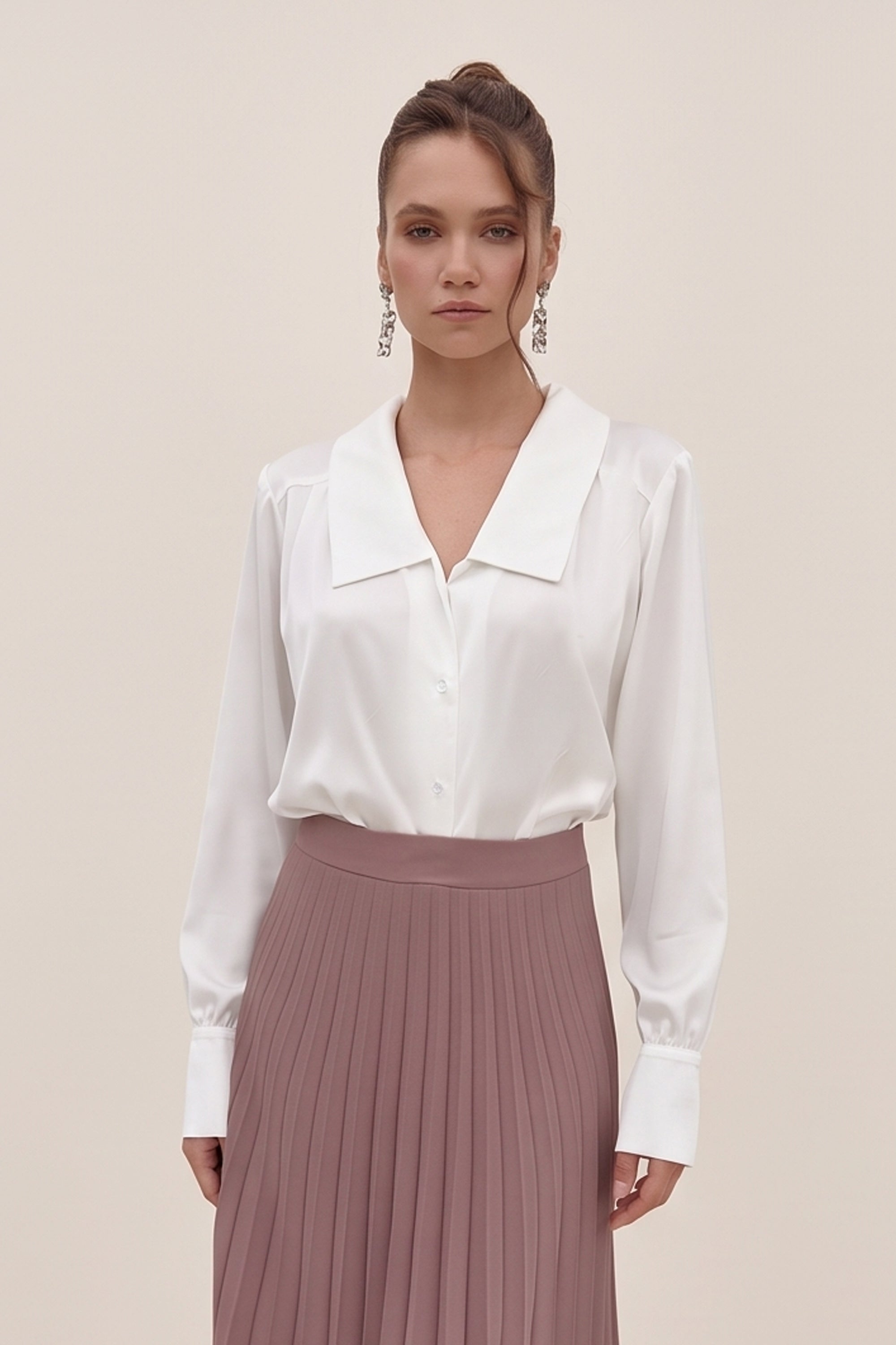 Front view of a woman wearing the white Timeless Blouse by FemeAdor featuring a flattering fit, ideal for layering or wearing solo in professional and casual settings.