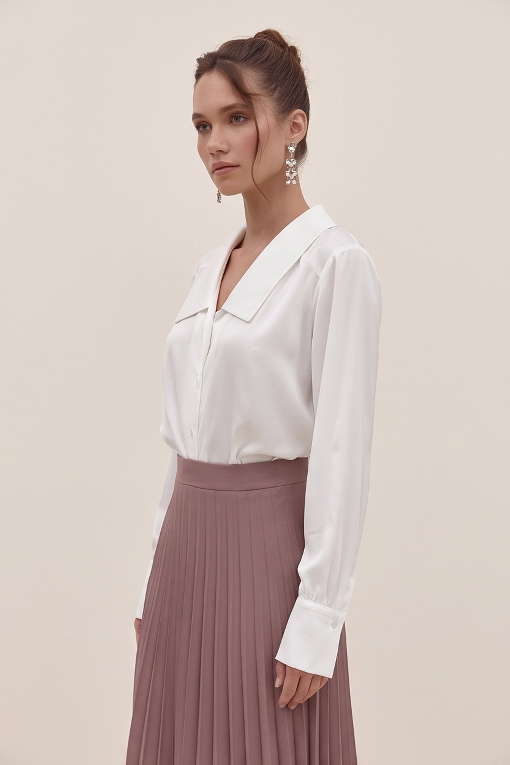 Side view of a woman wearing the white Timeless Blouse by FemeAdor featuring a flattering fit, ideal for layering or wearing solo in professional and casual settings.