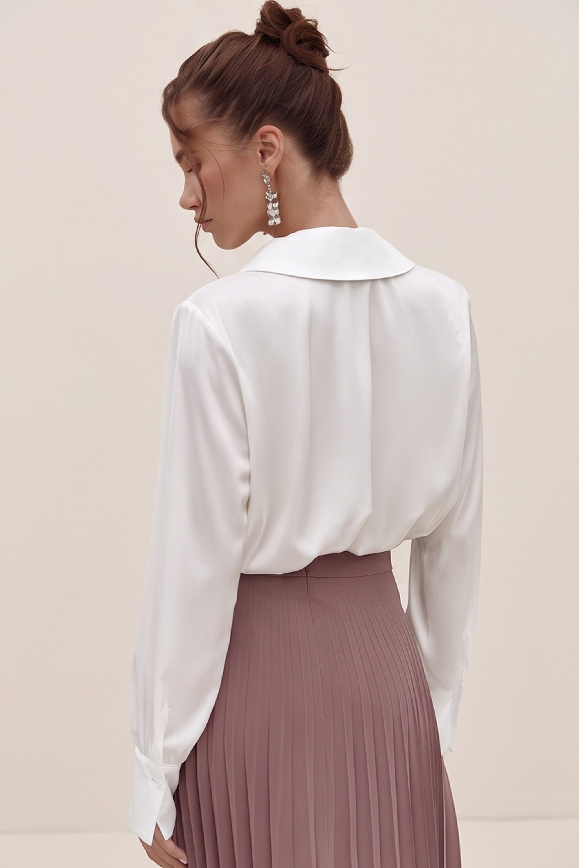Back view of a woman wearing the white Timeless Blouse by FemeAdor featuring a flattering fit, ideal for layering or wearing solo in professional and casual settings.