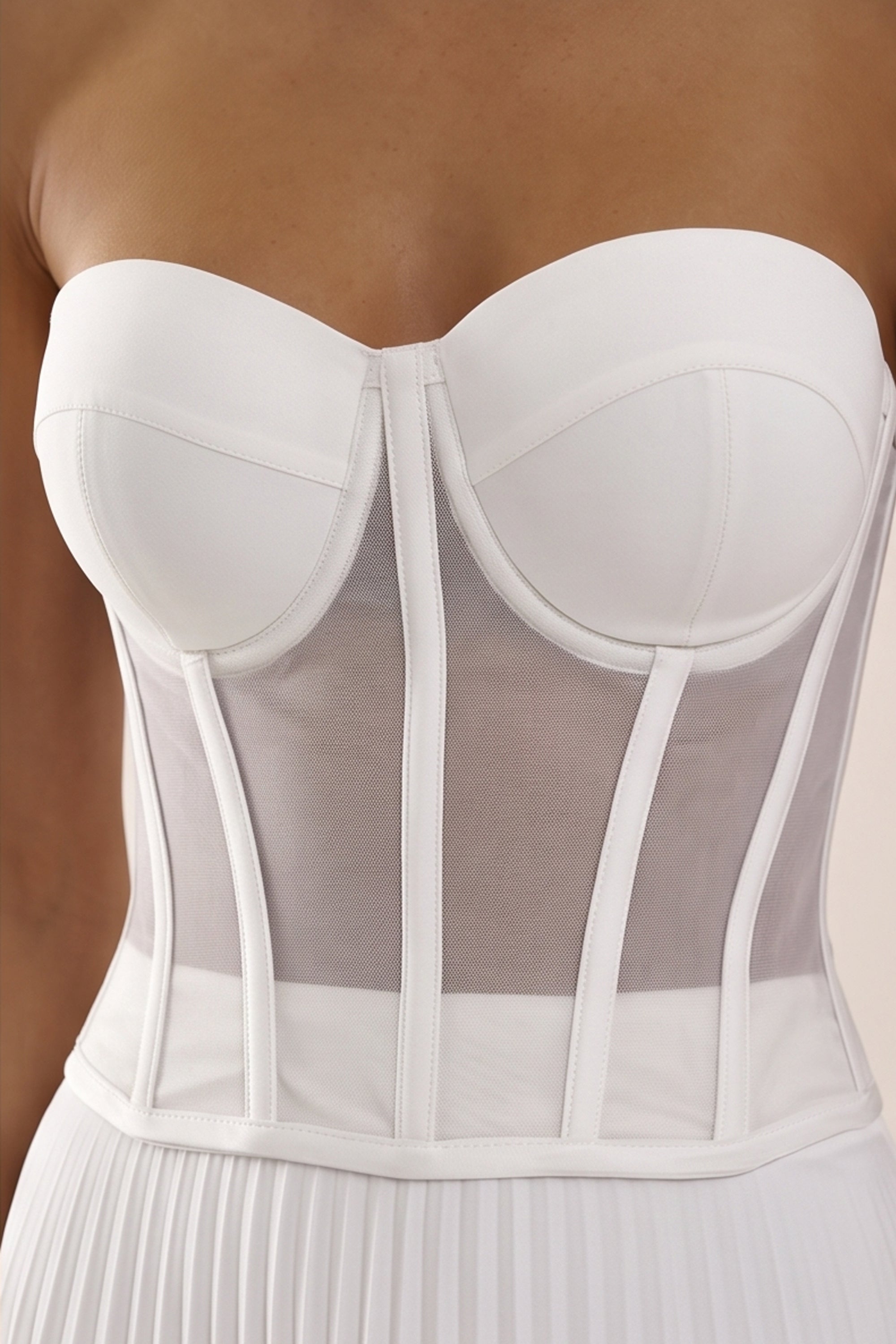 Close up view of a woman wearing the white Timeless Corset by Femeador with a structured fit, lace-up back and romantic silhouette